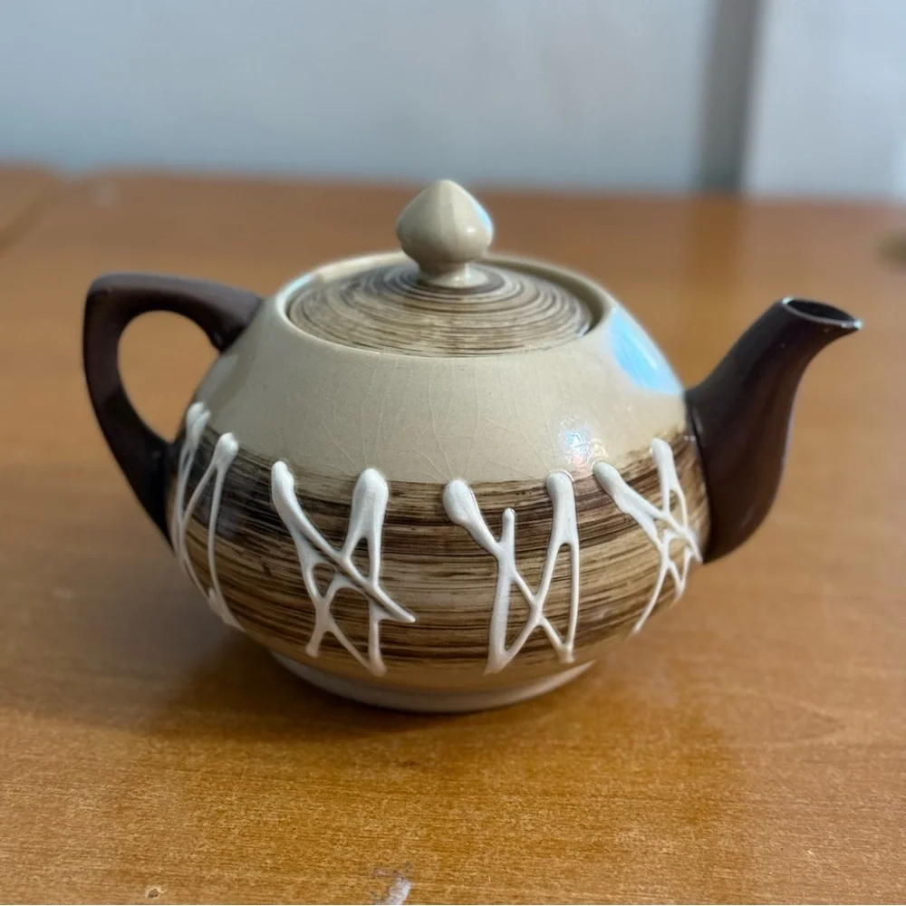 Antique brown and white ceramic teapot‎